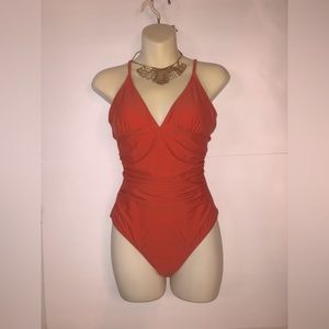 Beautiful rustic orange one piece V-cut bikini with waist snatching sides